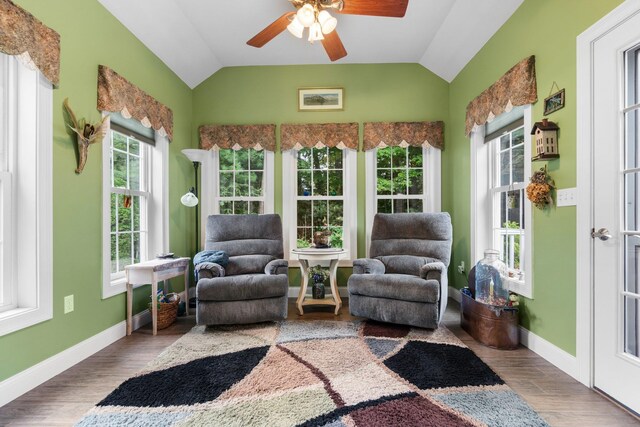 sunroom / solarium featuring lofted ceiling, plenty of natural light, and ceiling fan