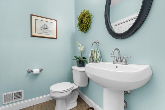 bathroom featuring hardwood / wood-style flooring, sink, and toilet