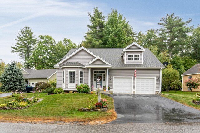 view of front of house with a garage and a front lawn