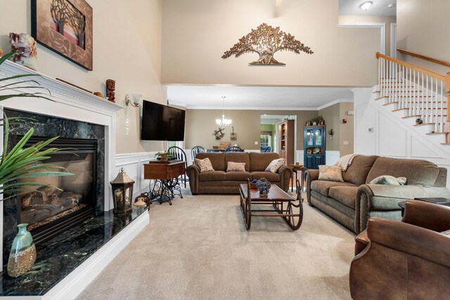 living room with a high end fireplace, ornamental molding, and light carpet