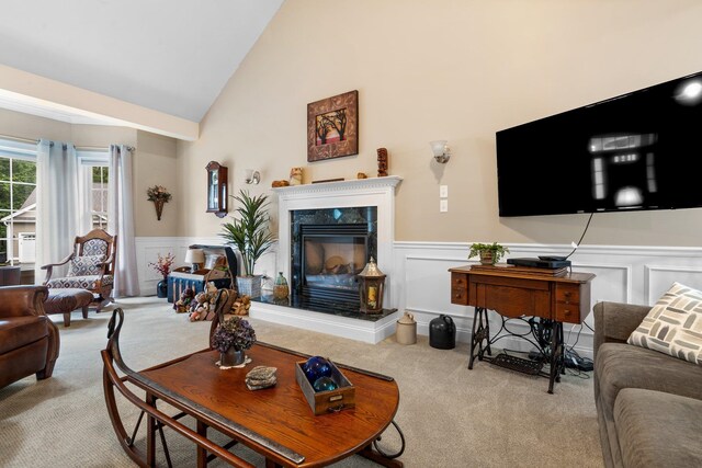 living room with light carpet, a fireplace, and high vaulted ceiling