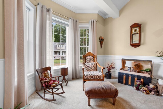 sitting room featuring light colored carpet and ornamental molding