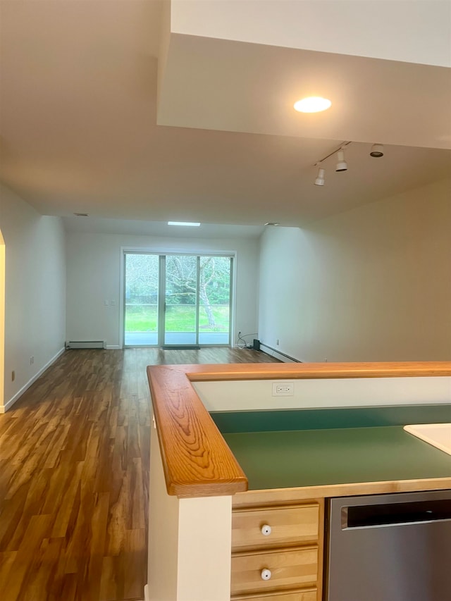 kitchen with butcher block countertops, a baseboard radiator, dark hardwood / wood-style floors, and dishwasher