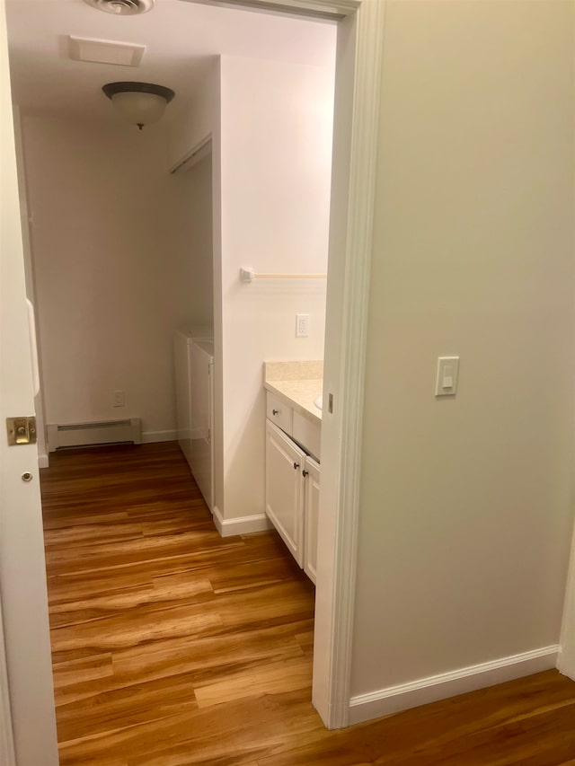 hallway featuring light hardwood / wood-style flooring and a baseboard radiator