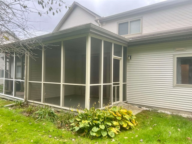 view of property exterior featuring a sunroom