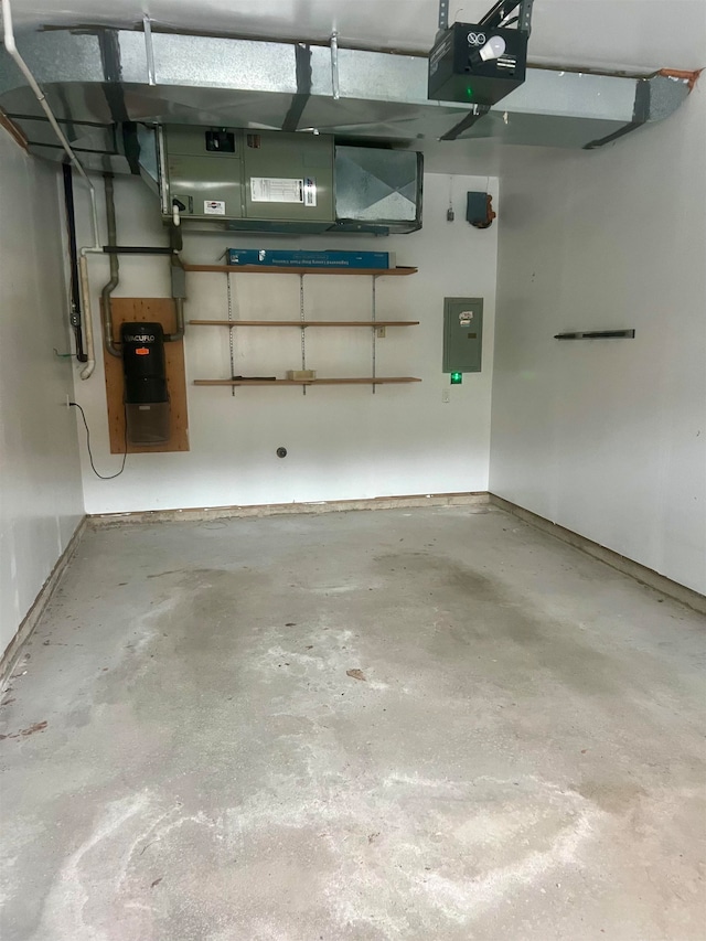 garage with electric panel and a garage door opener