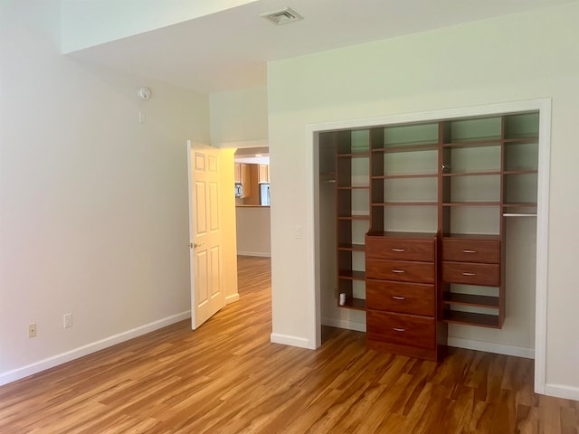 unfurnished bedroom featuring a closet and wood-type flooring