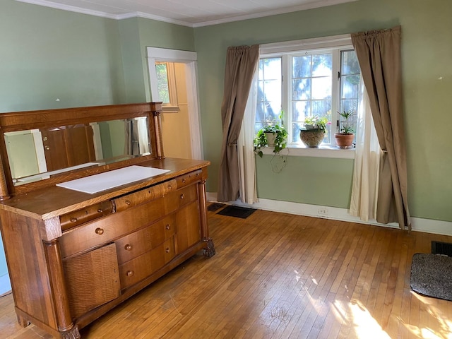 interior space featuring light hardwood / wood-style floors and ornamental molding