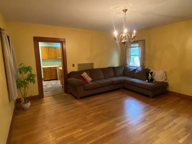 living room with light hardwood / wood-style flooring and a chandelier