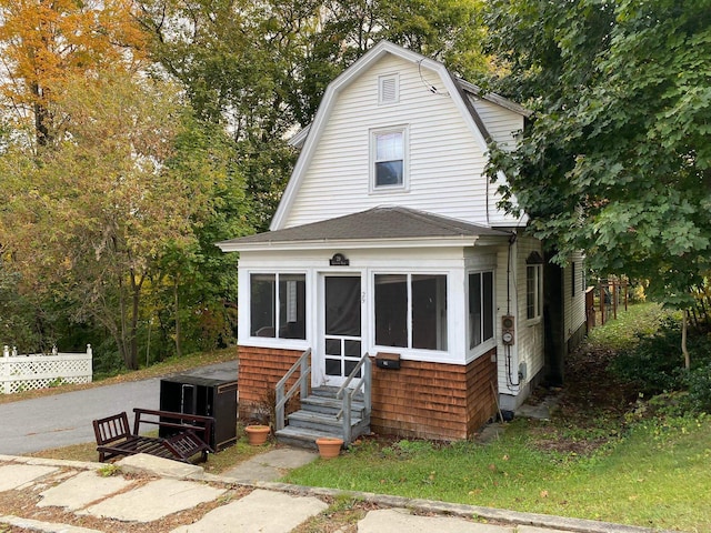 view of front of house featuring a sunroom