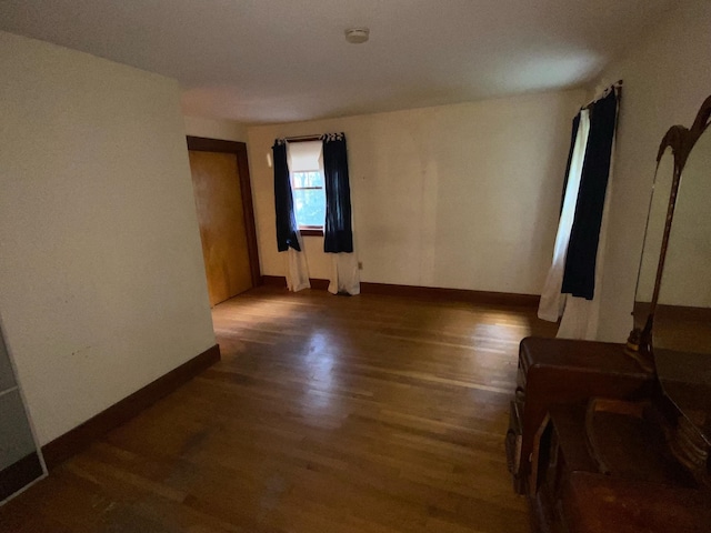 spare room with dark wood-type flooring