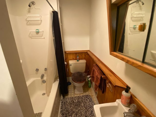 bathroom with shower / bath combo with shower curtain, wooden walls, and toilet