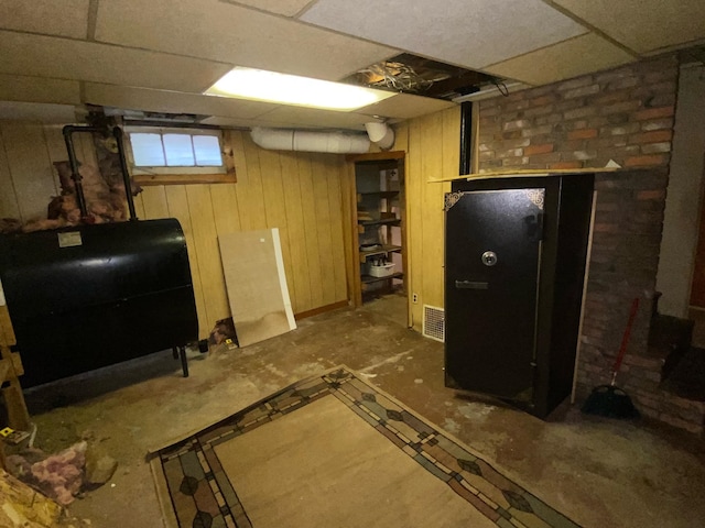 basement with a paneled ceiling