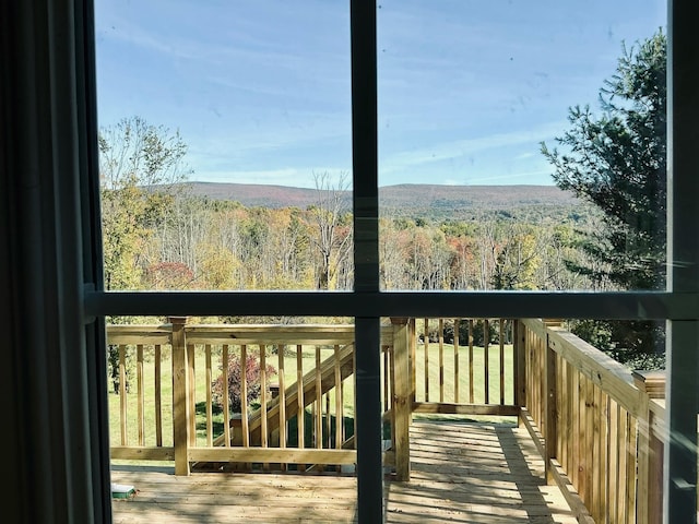 exterior space featuring hardwood / wood-style floors and a wooded view