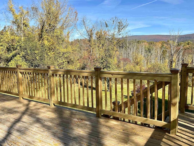 wooden deck featuring a forest view