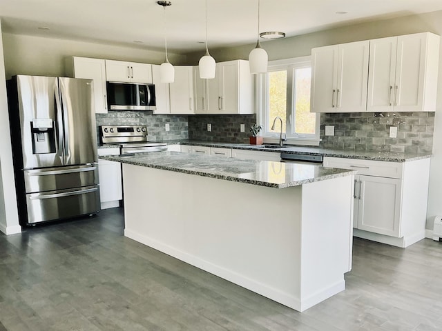 kitchen featuring a center island, a sink, white cabinetry, and stainless steel appliances