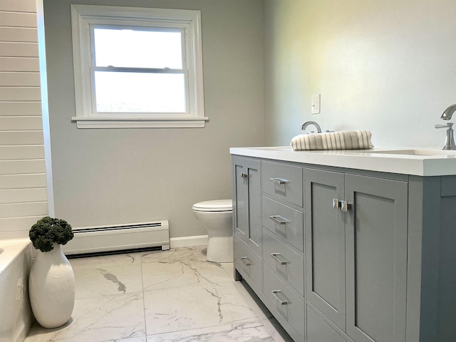 bathroom featuring a baseboard heating unit, marble finish floor, toilet, a bathtub, and baseboards