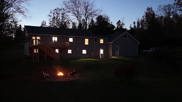 view of front of home featuring an outdoor fire pit, a wooden deck, and stairway