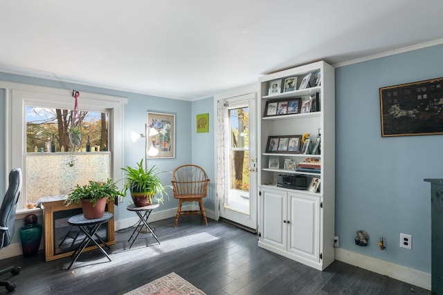 living area with a healthy amount of sunlight, dark hardwood / wood-style floors, and ornamental molding