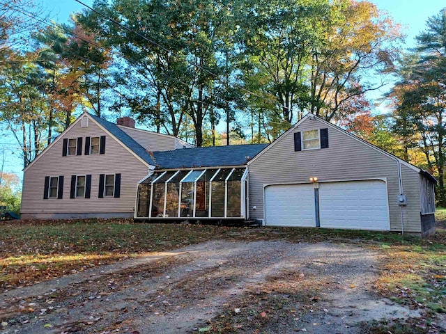 view of front of house with a garage and a sunroom