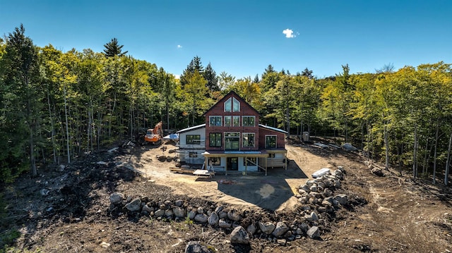 back of house with a deck and a patio