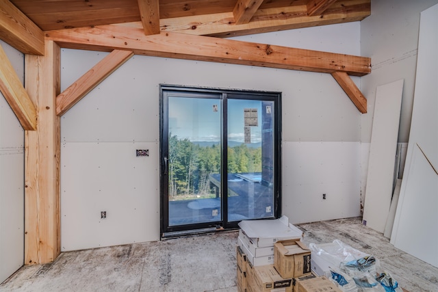 additional living space with vaulted ceiling with beams