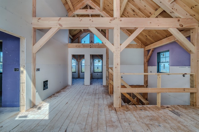 interior space featuring beam ceiling, high vaulted ceiling, wood ceiling, and hardwood / wood-style floors