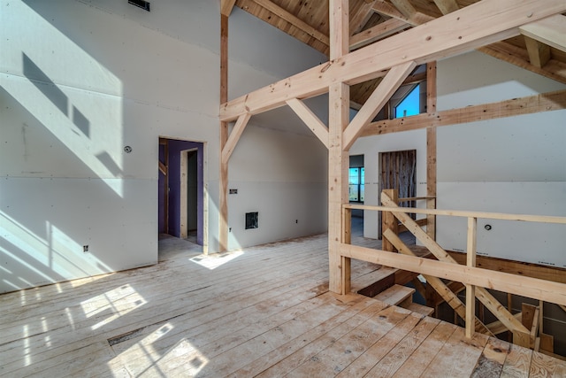 interior space with high vaulted ceiling and light hardwood / wood-style flooring