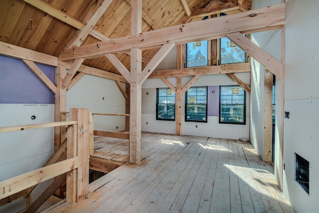 interior space with beamed ceiling, hardwood / wood-style floors, high vaulted ceiling, and wooden ceiling