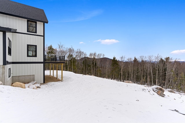 yard layered in snow with a wooden deck