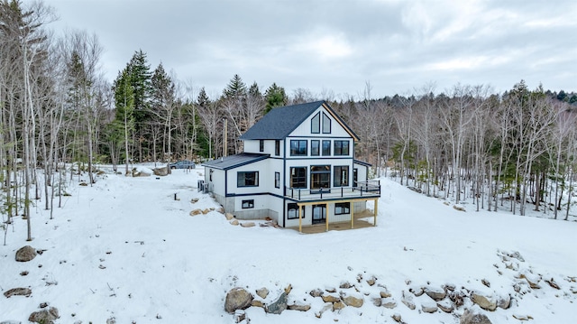 snow covered house with a deck