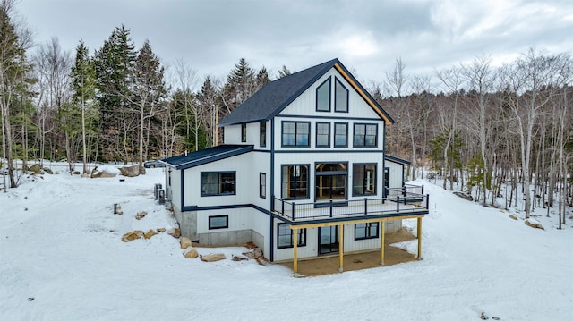 view of snow covered rear of property