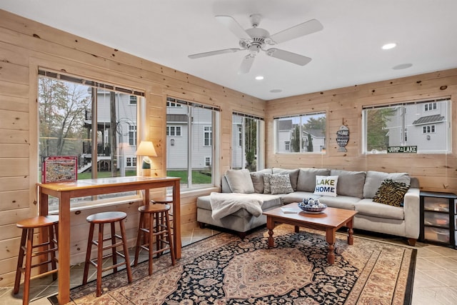 living room with plenty of natural light and wooden walls