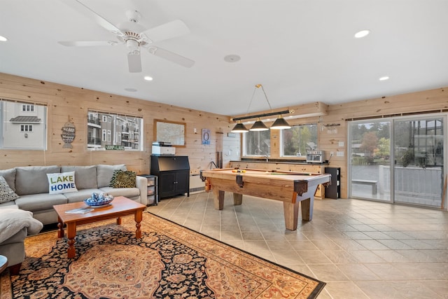 game room featuring light tile patterned flooring, ceiling fan, wood walls, and billiards