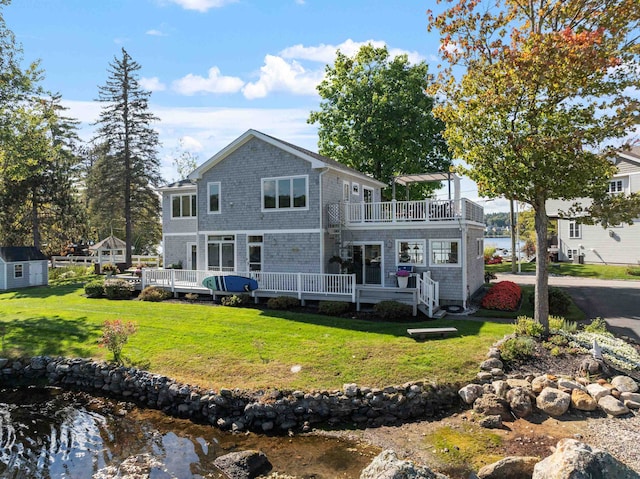 back of house with a lawn and a deck