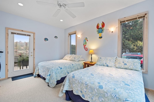 carpeted bedroom featuring ceiling fan, access to exterior, and multiple windows