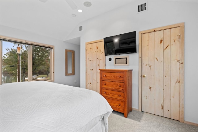 bedroom featuring ceiling fan, lofted ceiling, and light carpet