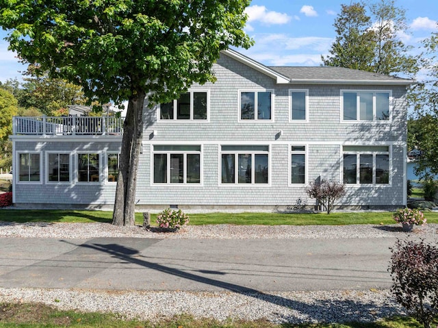 back of property featuring a balcony