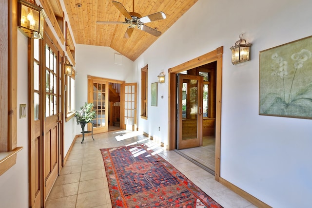 hallway with french doors, wooden ceiling, high vaulted ceiling, and light tile patterned floors