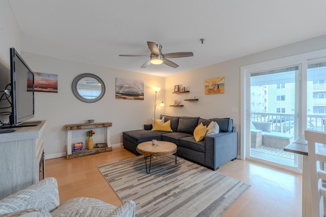 living room featuring light wood-type flooring and ceiling fan