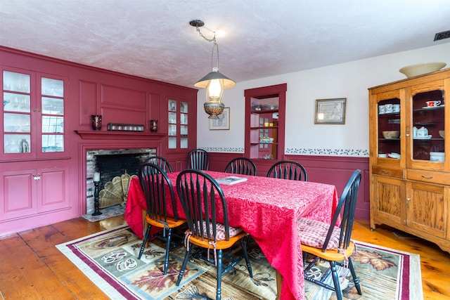 dining room with hardwood / wood-style flooring and a textured ceiling