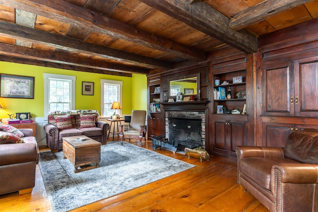 living room with a fireplace, wooden ceiling, beamed ceiling, and hardwood / wood-style flooring