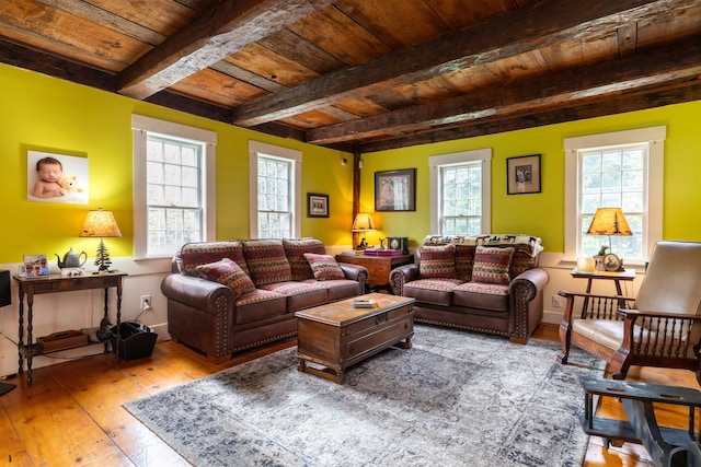 living room featuring light hardwood / wood-style floors, wooden ceiling, and a wealth of natural light