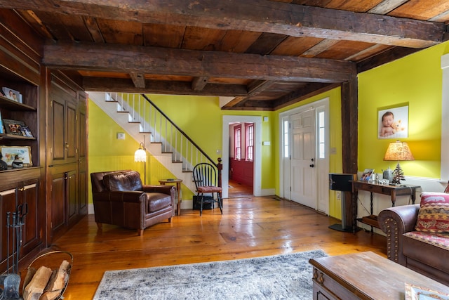 entrance foyer featuring beamed ceiling, wooden ceiling, and light hardwood / wood-style floors