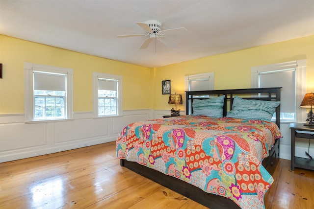 bedroom with light hardwood / wood-style flooring and ceiling fan