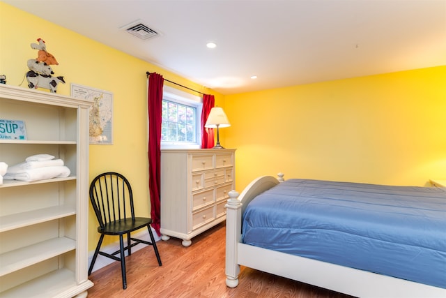 bedroom with hardwood / wood-style floors