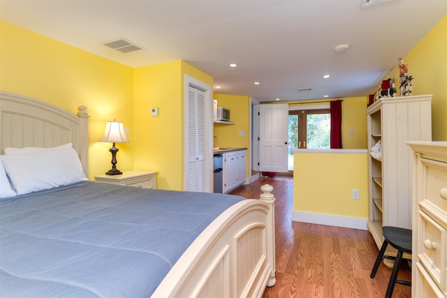 bedroom featuring french doors, hardwood / wood-style flooring, and a closet