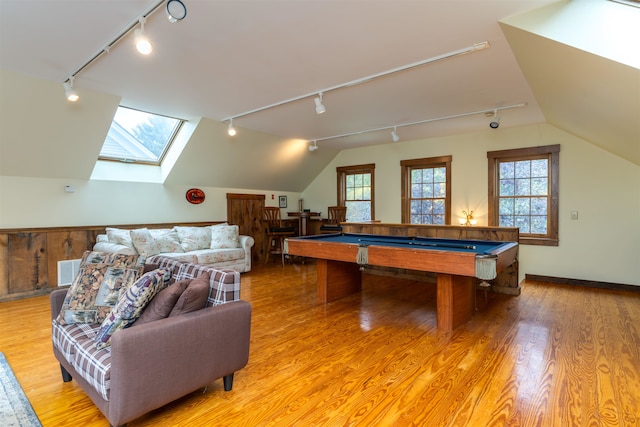 game room with light wood-type flooring, pool table, rail lighting, and vaulted ceiling with skylight