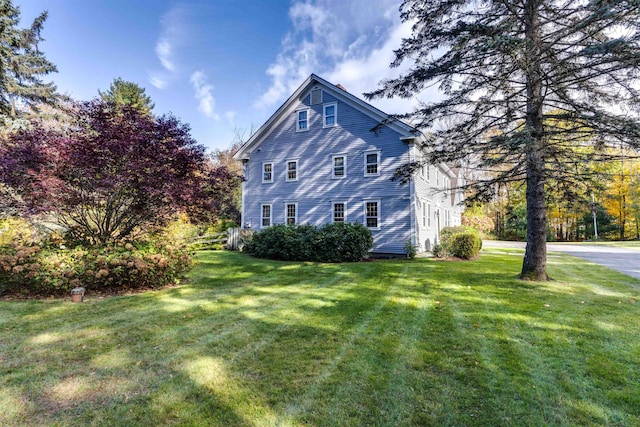 view of property exterior with a yard