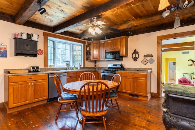 kitchen featuring ceiling fan, beamed ceiling, appliances with stainless steel finishes, and dark hardwood / wood-style floors